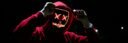 A spooky illuminated mask figure with a red hoodie in a dark setting, perfect for Halloween themes.